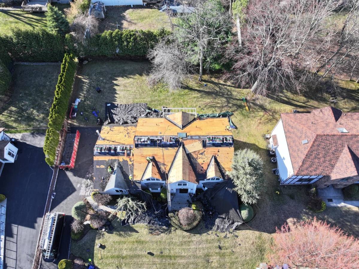 Aerial drone shot of a Storm Division project mid-replacement, decking exposed, crew on site